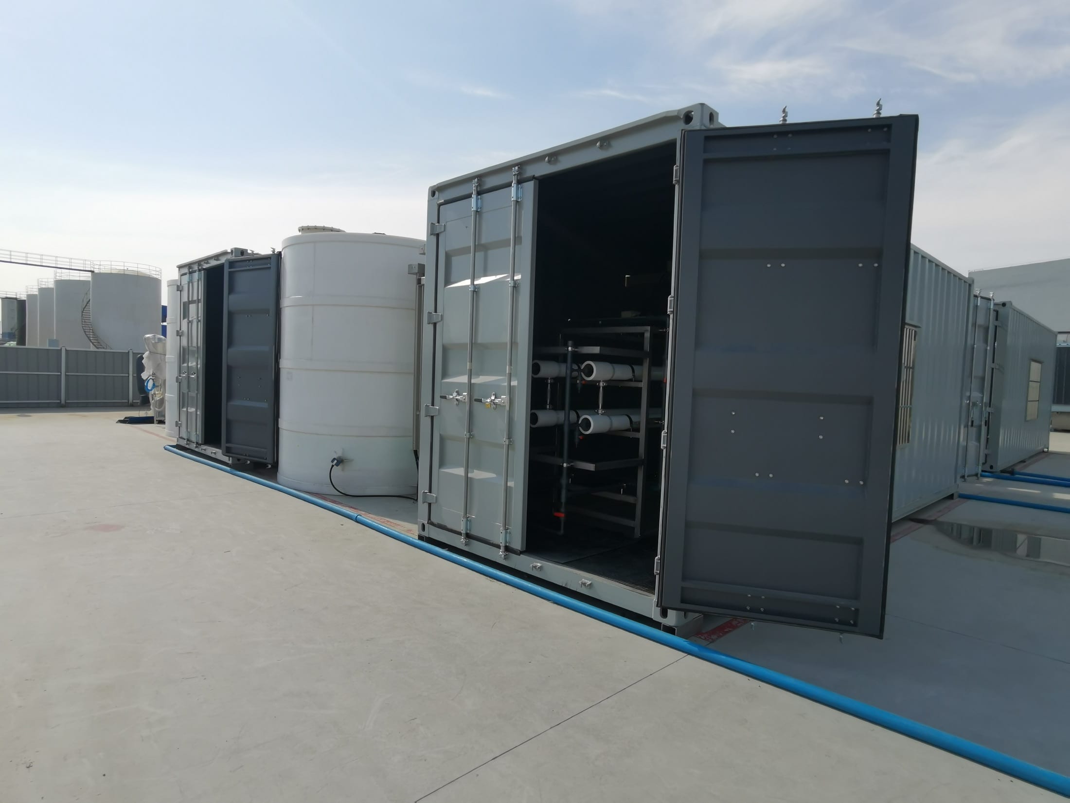 Installed containerized membrane-treatment system relevant to industrial waste salt and fly ash wash water resource-recovery routes
